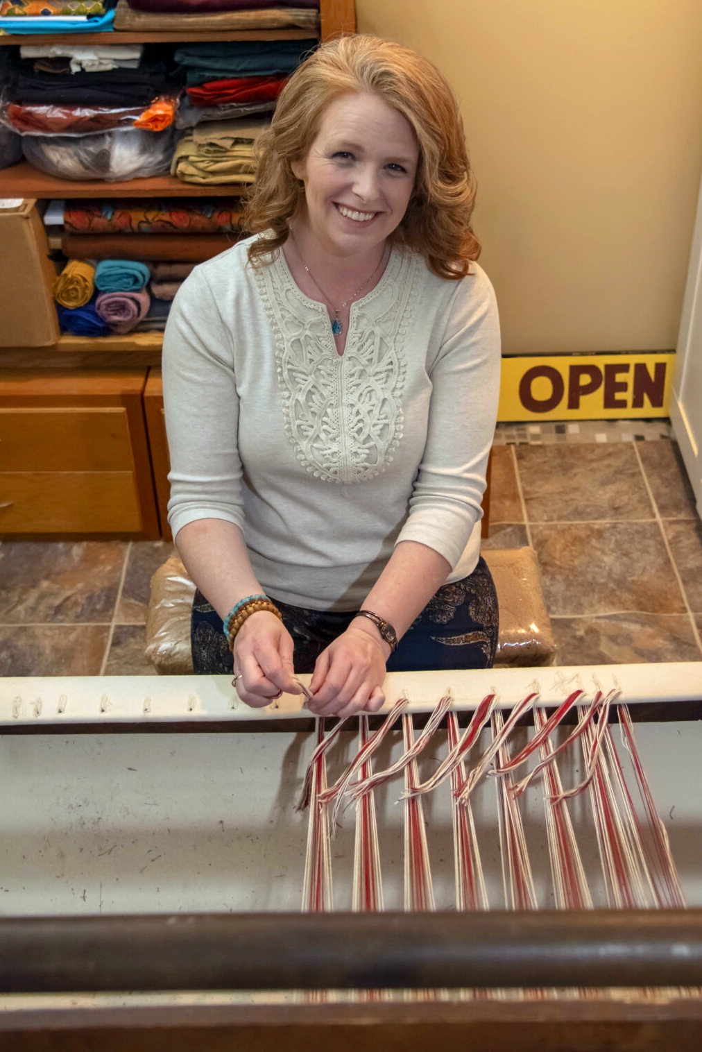 A emily with her smiling face and working on the wooden machine